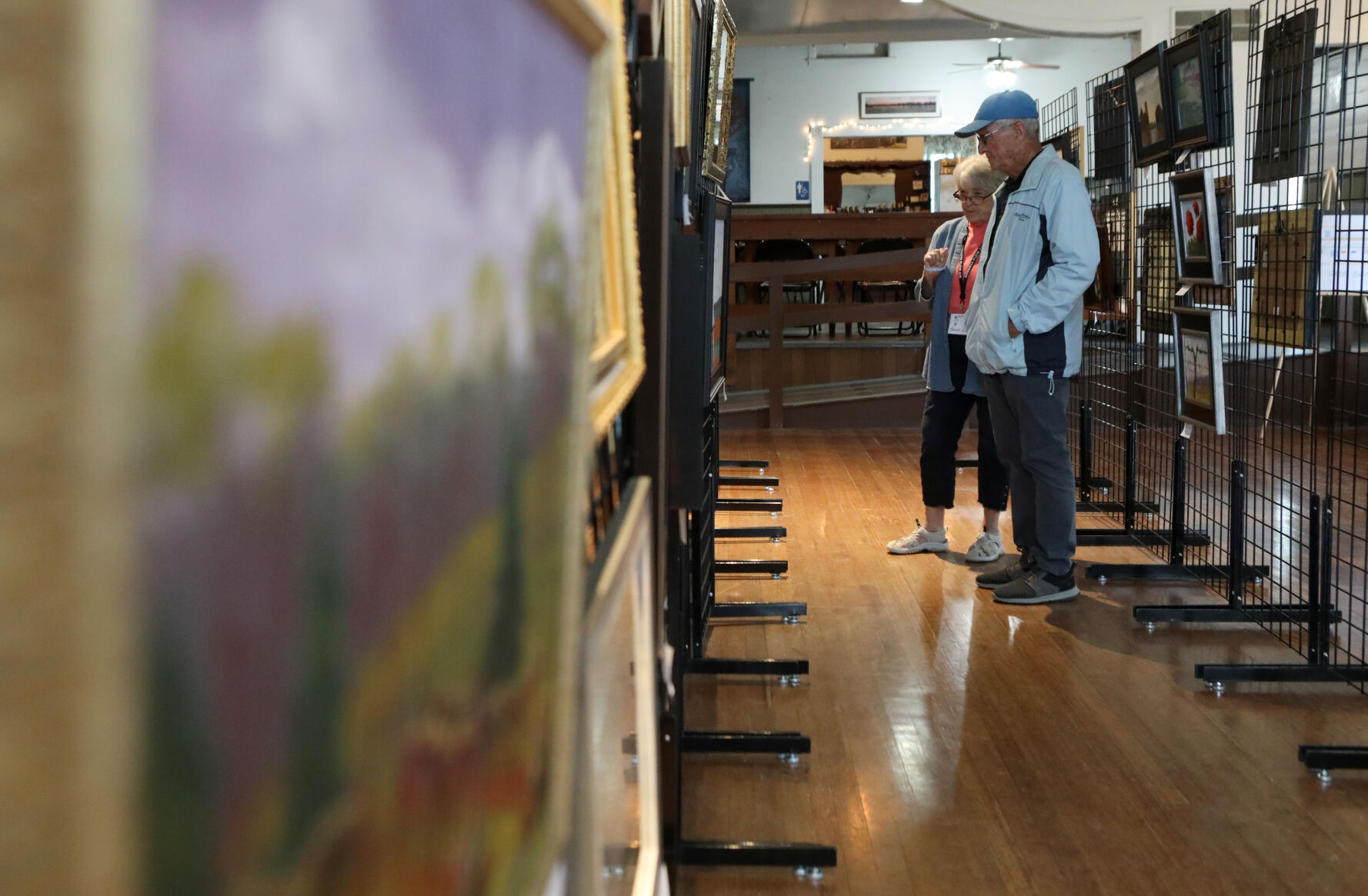 Corinne and Gary Post look at paintings